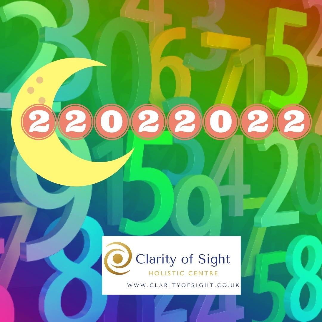 The date 22/02/2022 displayed symbolically with numerology and spiritual imagery representing balance and duality
